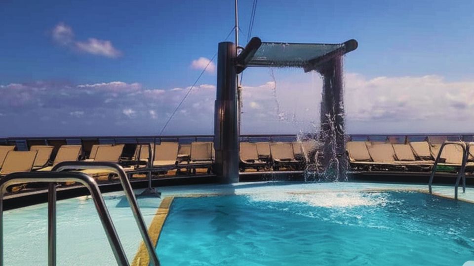 Piscina externa na popa do Costa Diadema, com espreguiçadeiras e vista para o mar.