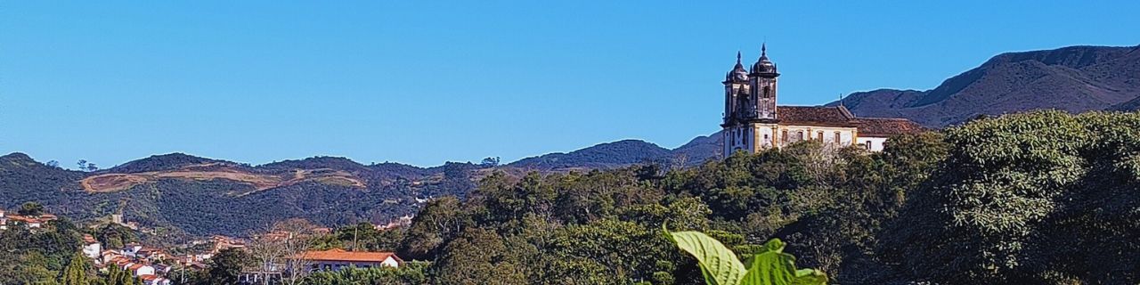 Banner principal do site: Minas Gerais: terra de montanhas, cachoeiras, lugares históricos, gastronomia única e a Estrada Real